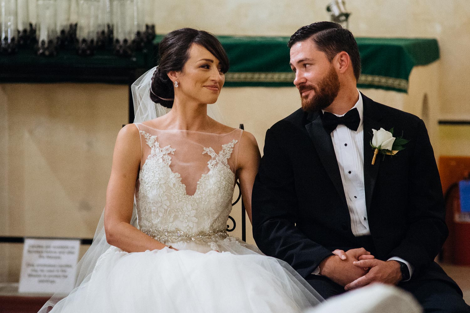 Couple glance at each other during wedding ceremony at Mission Concepcion Wedding