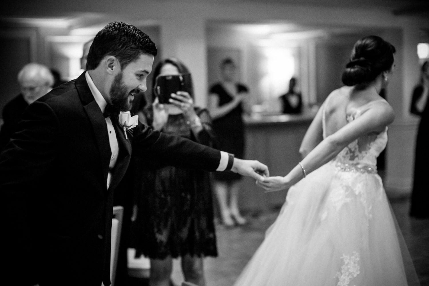 Bride gently holds hands with groom Wedding St Anthony Reception-Philip Thomas