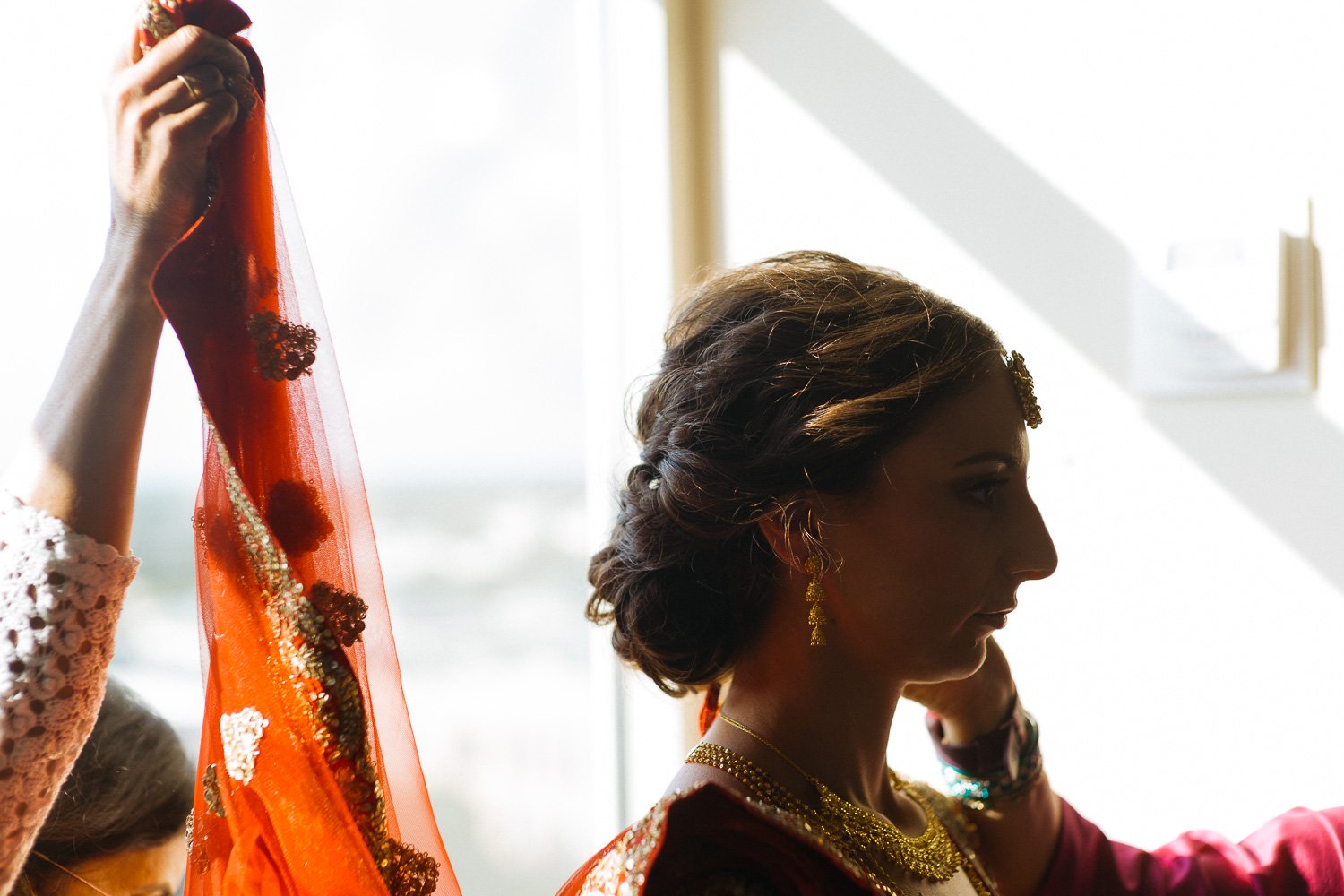 A Hindu bride has a wedding veil fitted Hindu Jewish fusion wedding Sugar Land Marriott Hotel Texas-022