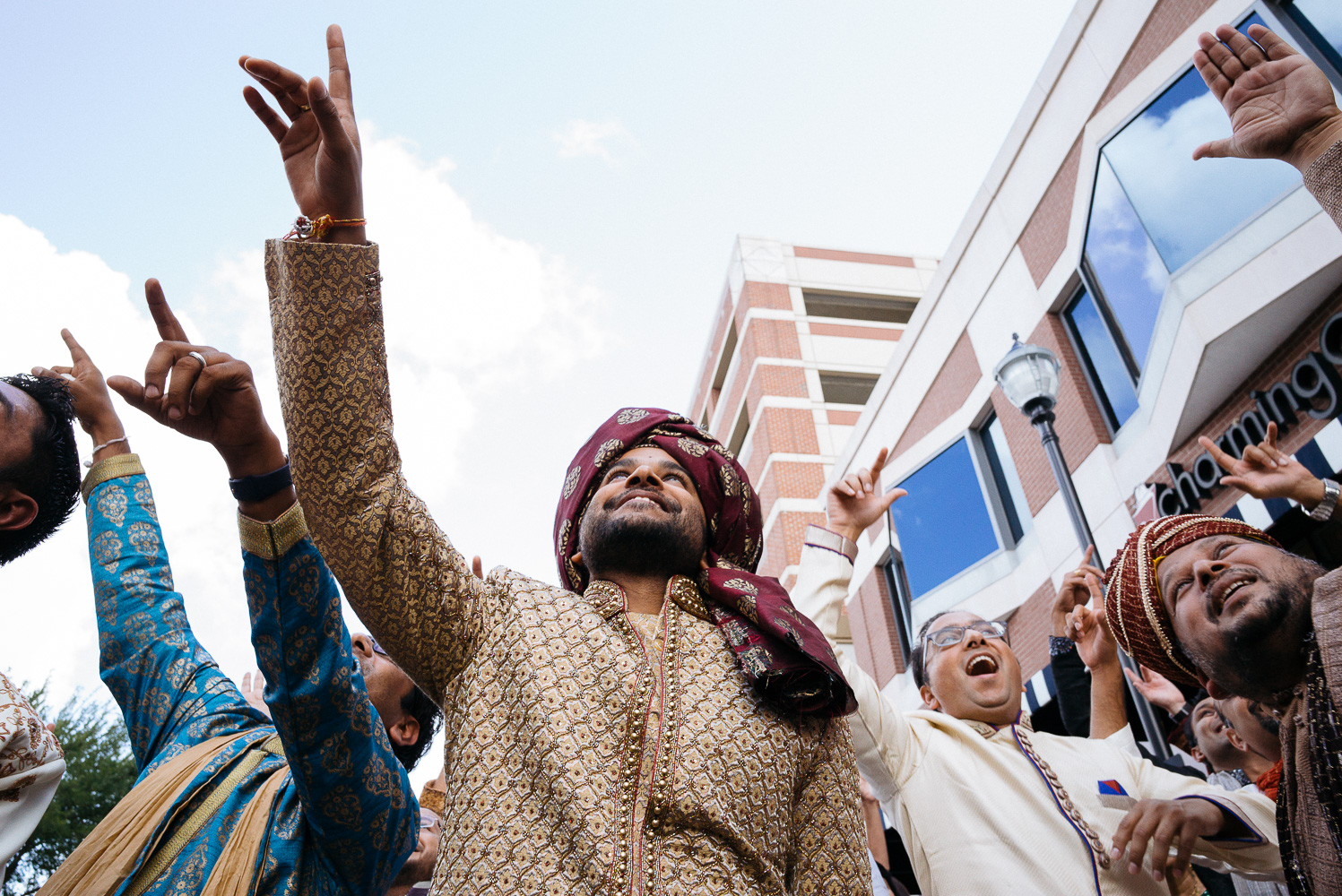 Groom surrounded by family during baraat Hindu Jewish fusion wedding Sugar Land Marriott Hotel Texas-037