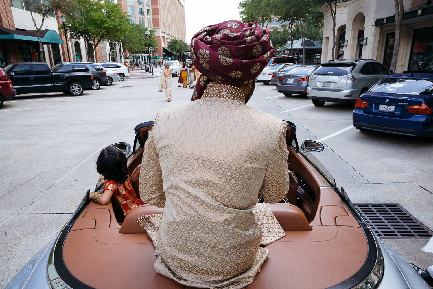 Shot from behind the groom as he arrives during the Baraat Hindu Jewish fusion wedding Sugar Land Marriott Hotel Texas-040