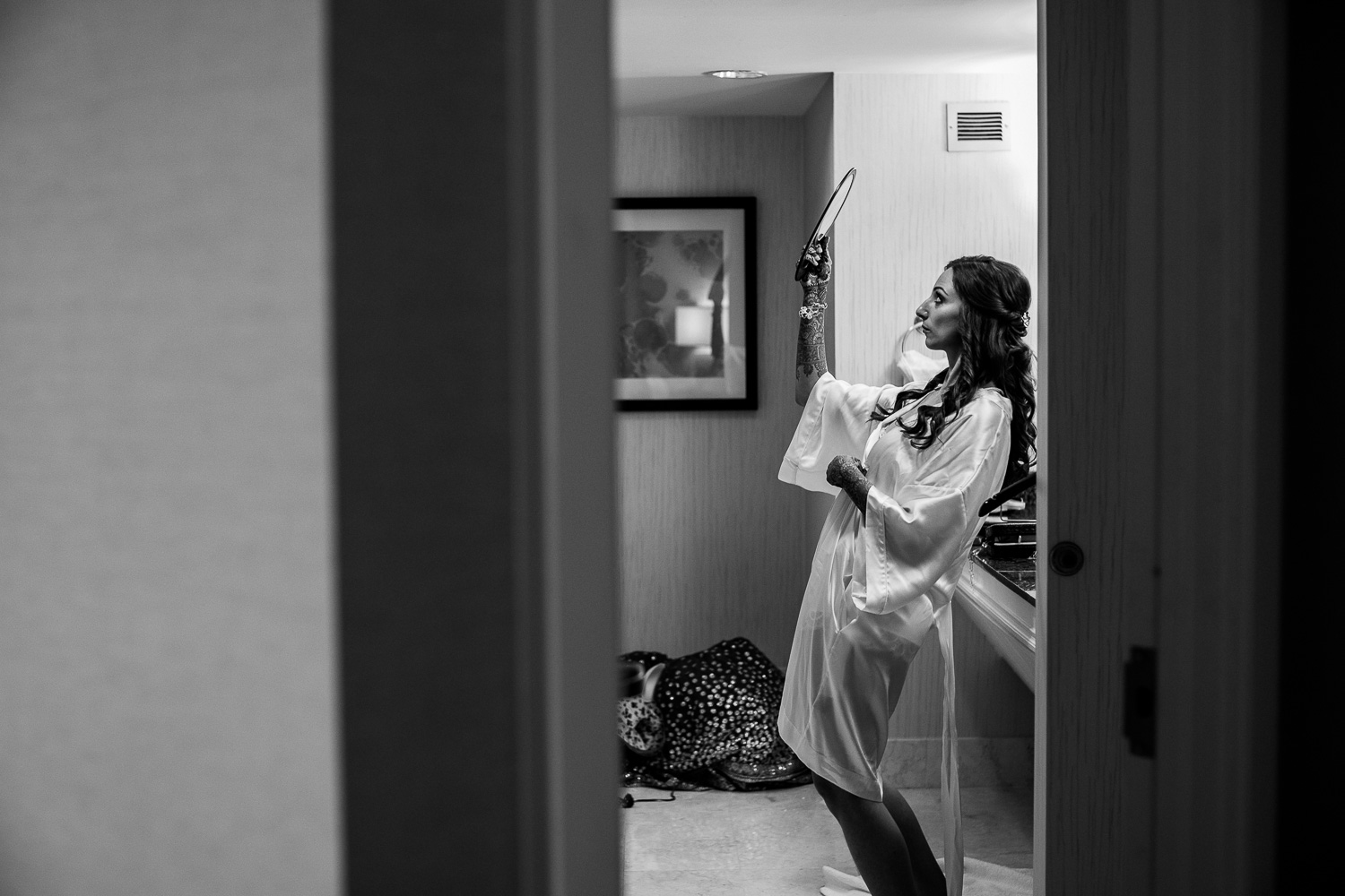 Kathryn checks herself in mirror Hindu Jewish fusion wedding Sugar Land Marriott Hotel Texas-056