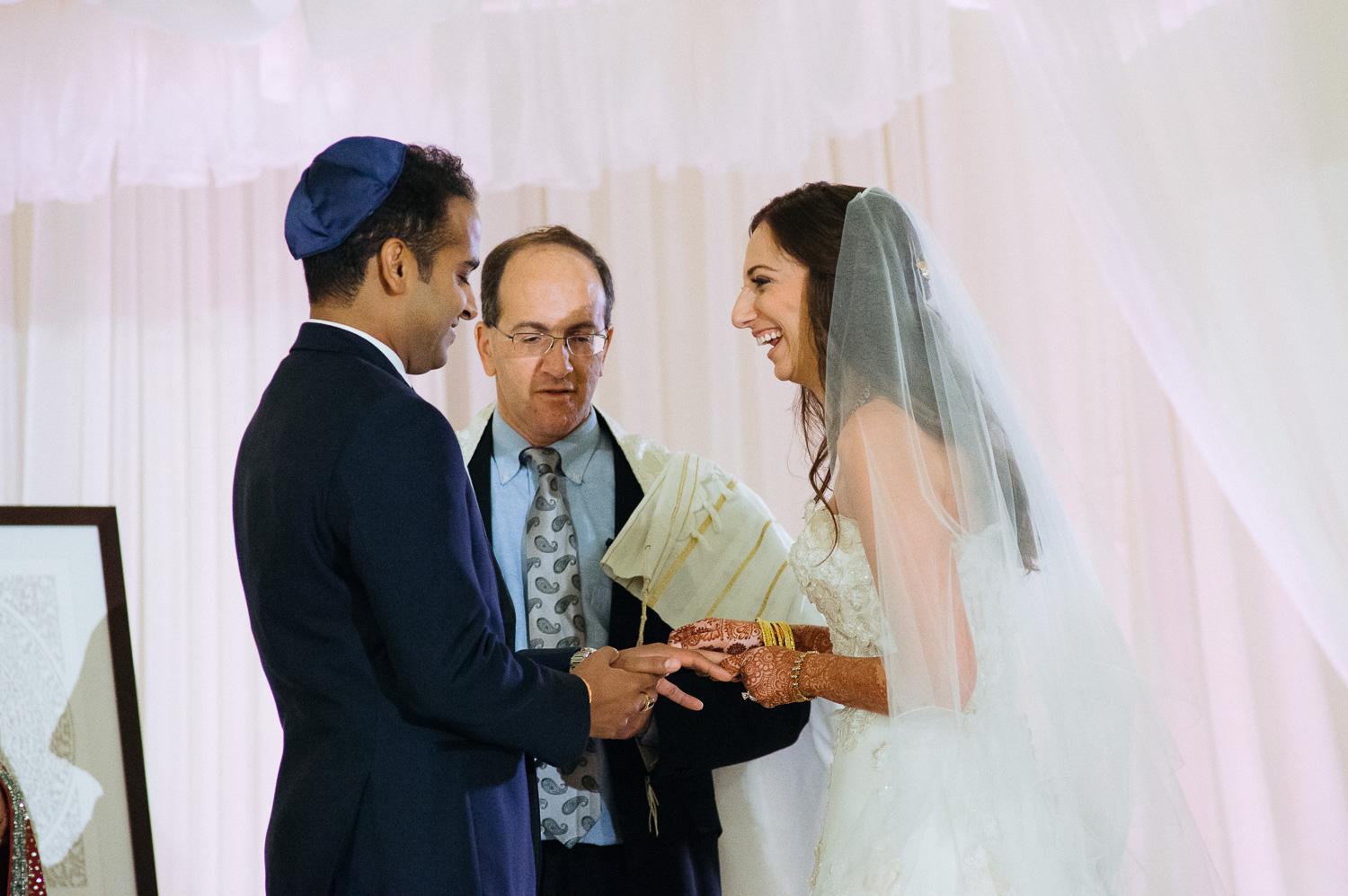A joke is shared during the jewish ceremony Hindu Jewish fusion wedding Sugar Land Marriott Hotel Texas-072