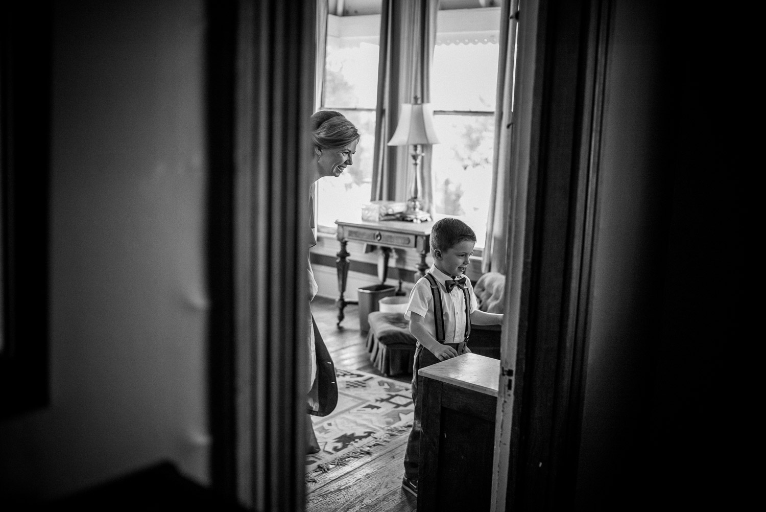 Ring bearer and a proud mother check the mirror at Barr Mansion Austin Wedding Photos-Philip Thomas