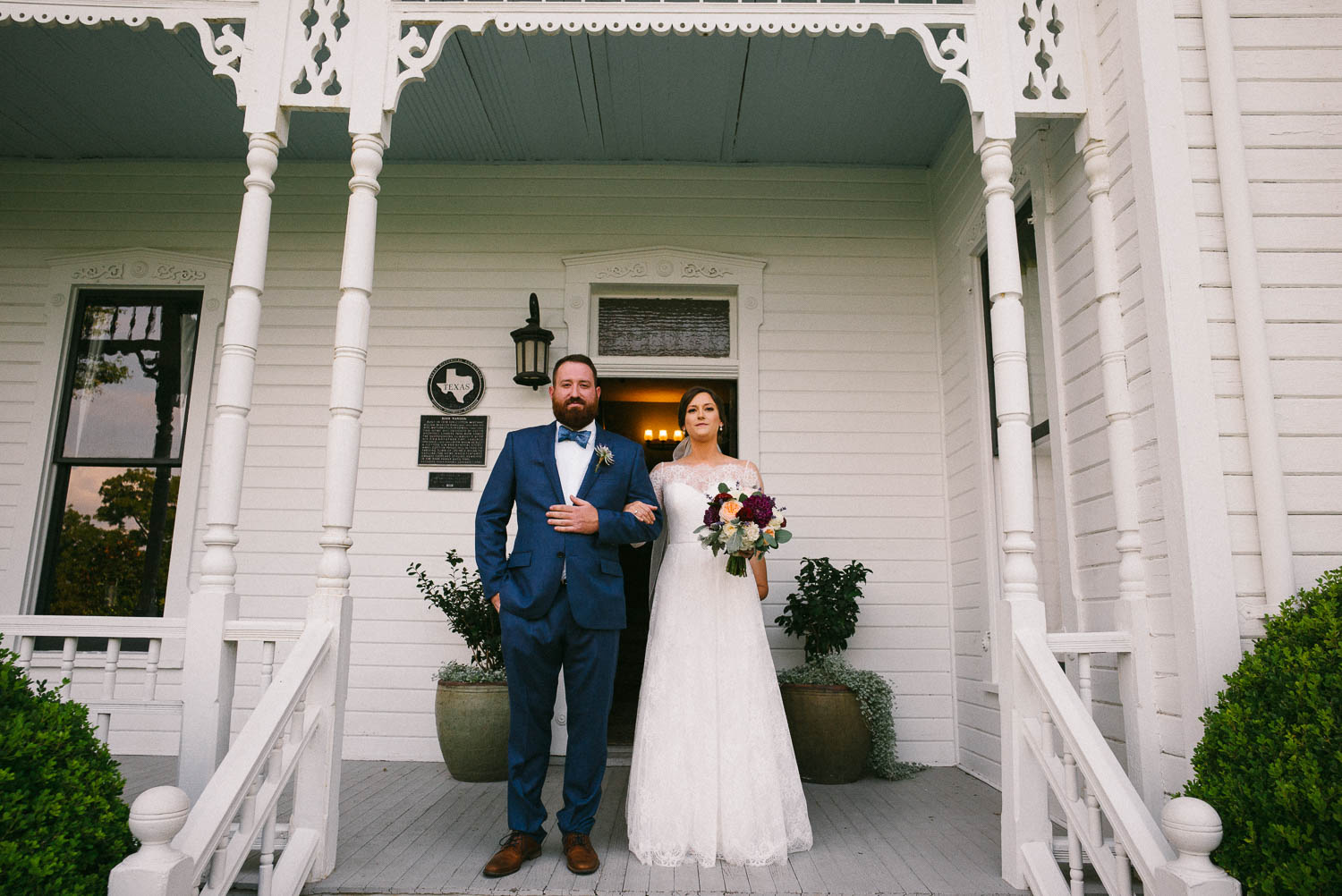 Bride and brother gather on the porch as they descend staircase toward ceremony at Barr Mansion Austin Wedding Photos-Philip Thomas
