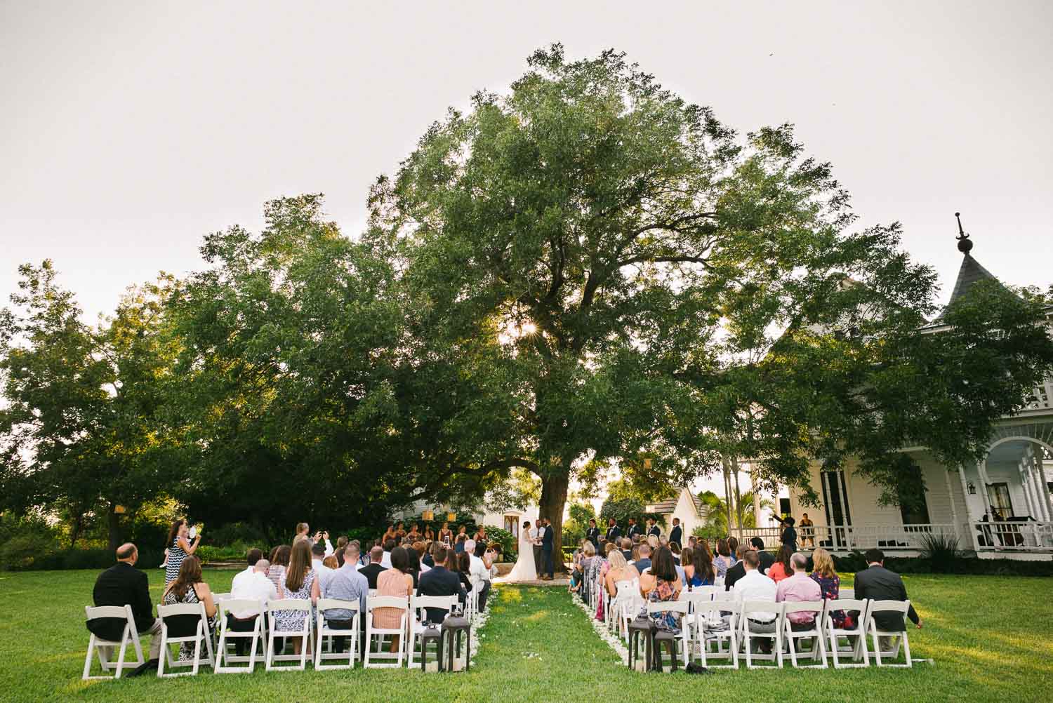 Wide shot looking from the back toward couple of old oak tree and ceremony Barr Mansion Austin Wedding Photos-Philip Thomas