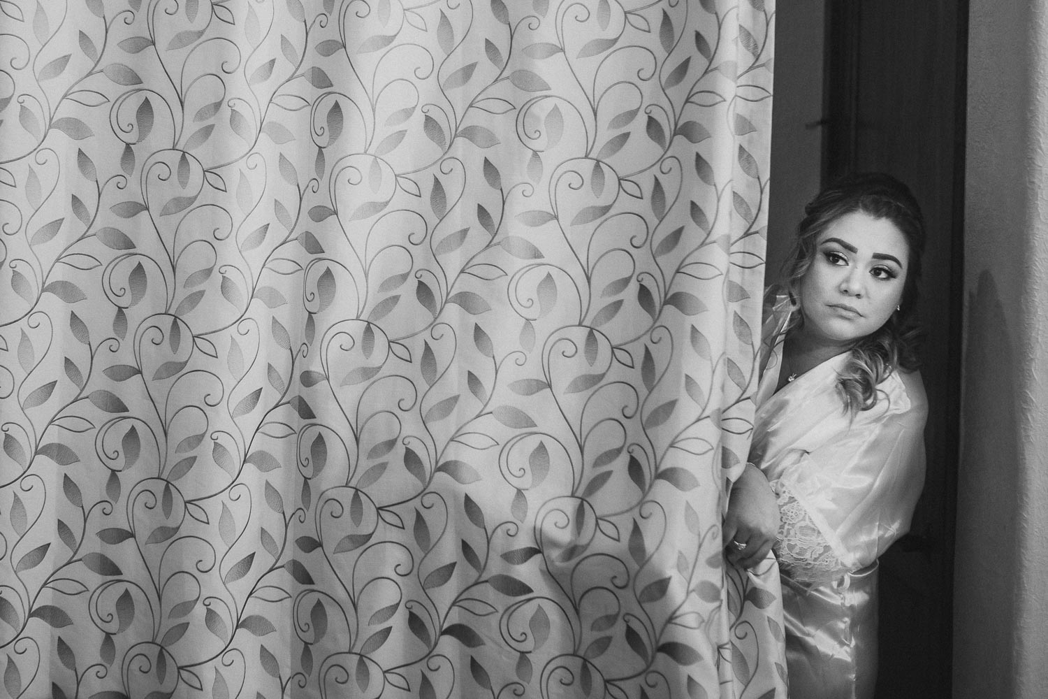 The bride peeks out from behind a curtain at The Springs Event Venue Wedding Photos-Philip Thomas