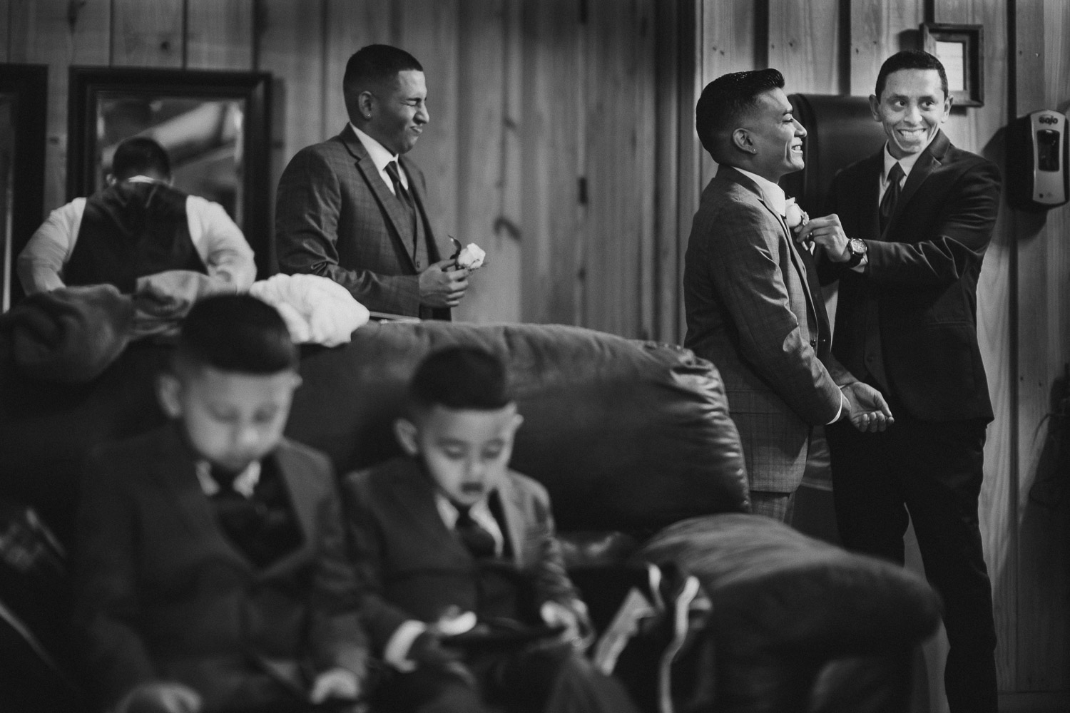 Groom laces flower on best man with the groomsmen's room at the Springs Event Venue Wedding Photos-Philip Thomas
