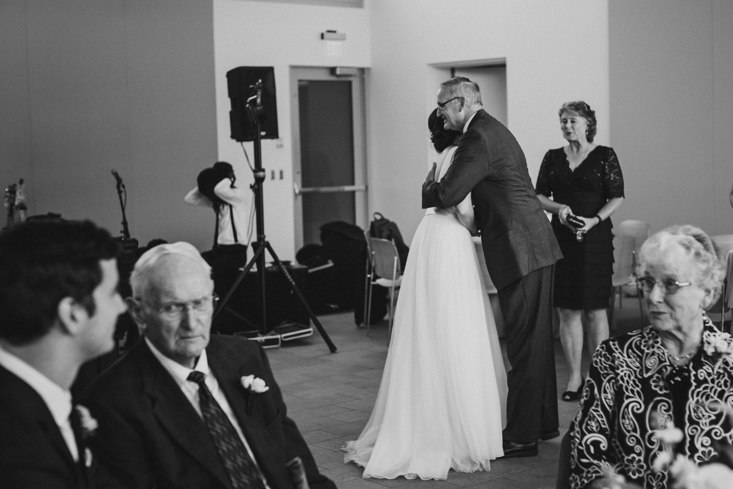 Family hugs between bride and family friend Cherie Flores Garden Pavilion Wedding Hermann Park Houston Texas-Philip Thomas