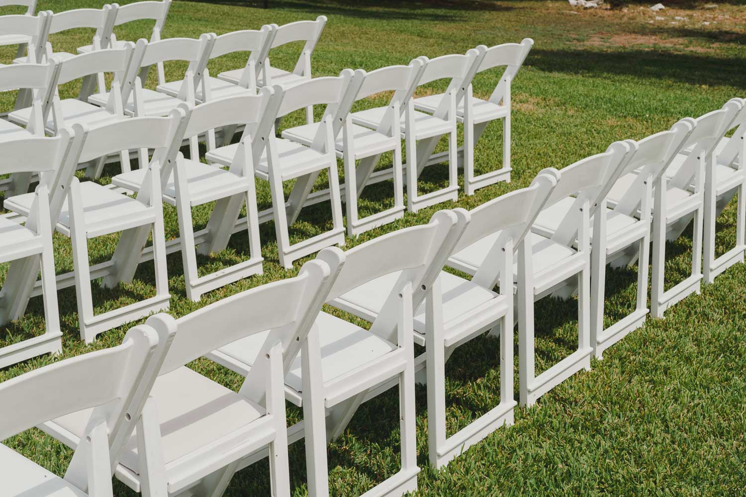 White ceremony Chairs lined up at The Springs Event Venue Wedding Photos-Philip Thomas