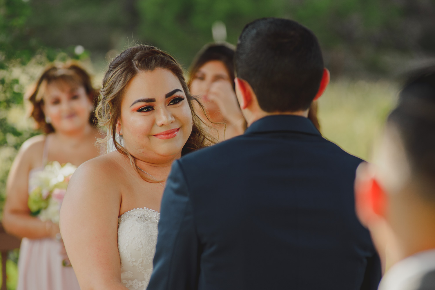 Alliison looks on lovingly to Eric the groom during their wedding ceremony at The Springs Event Venue Wedding Photos-Philip Thomas