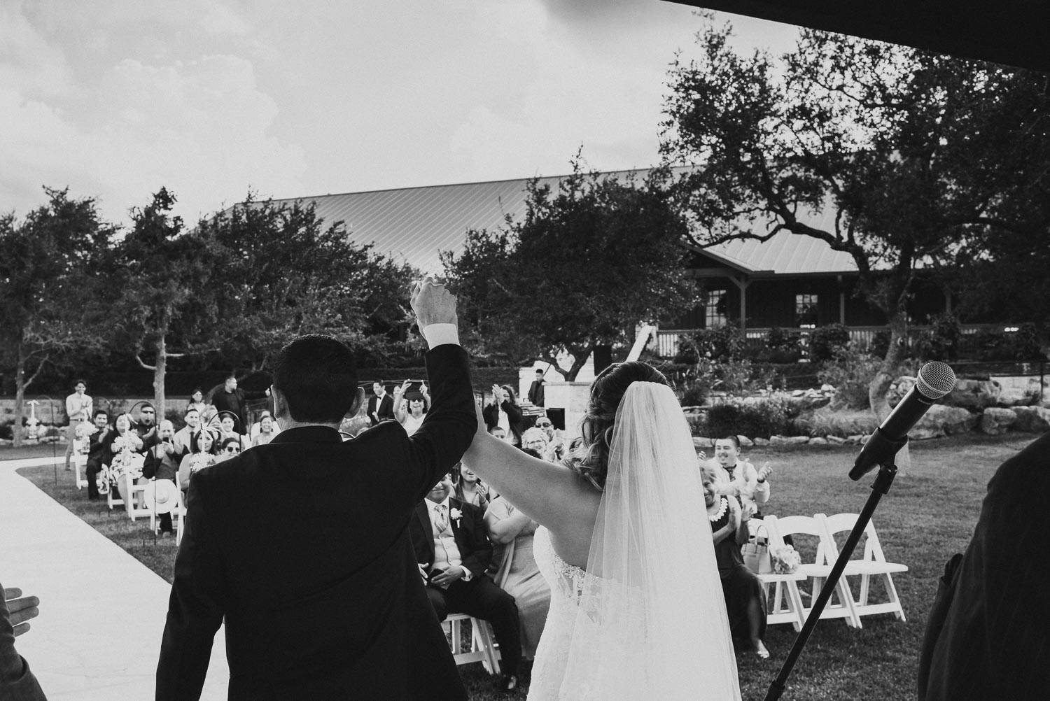 The couple raise their hands in union at The Springs Event Venue Wedding Photos-Philip Thomas