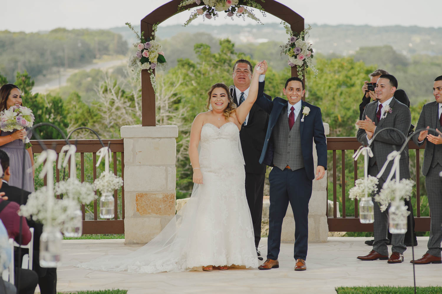 Couple joyously raise their hands to celebrate their unison of marriage at The Springs Event Venue Wedding Photos-Philip Thomas