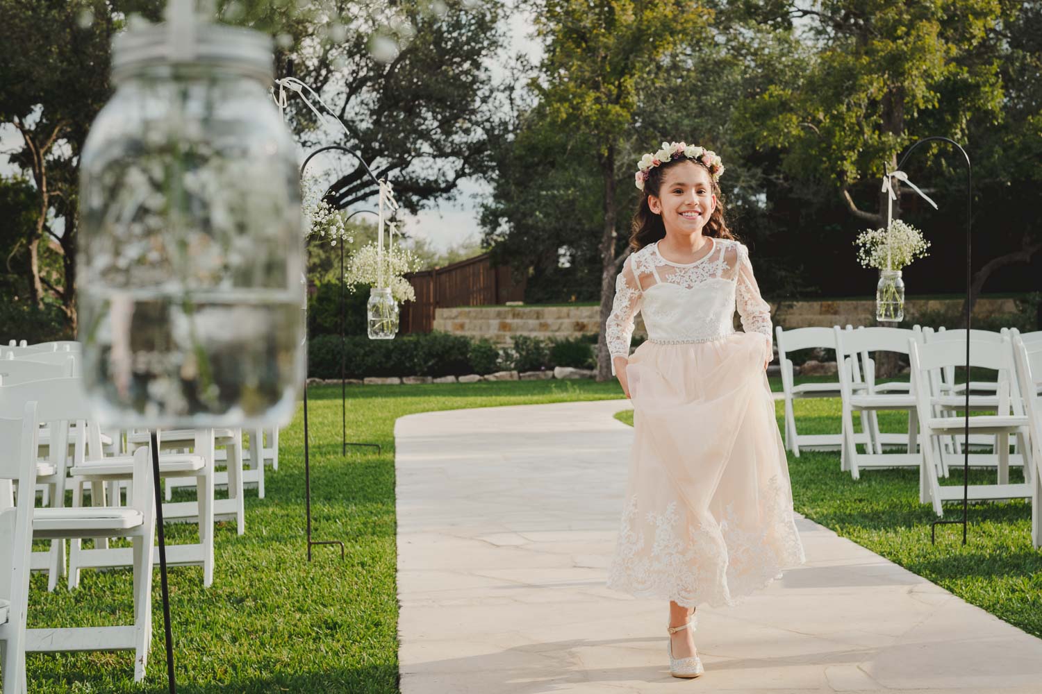 Flowergirl runs down the aisle at The Springs Event Venue Wedding Photos-Philip Thomas