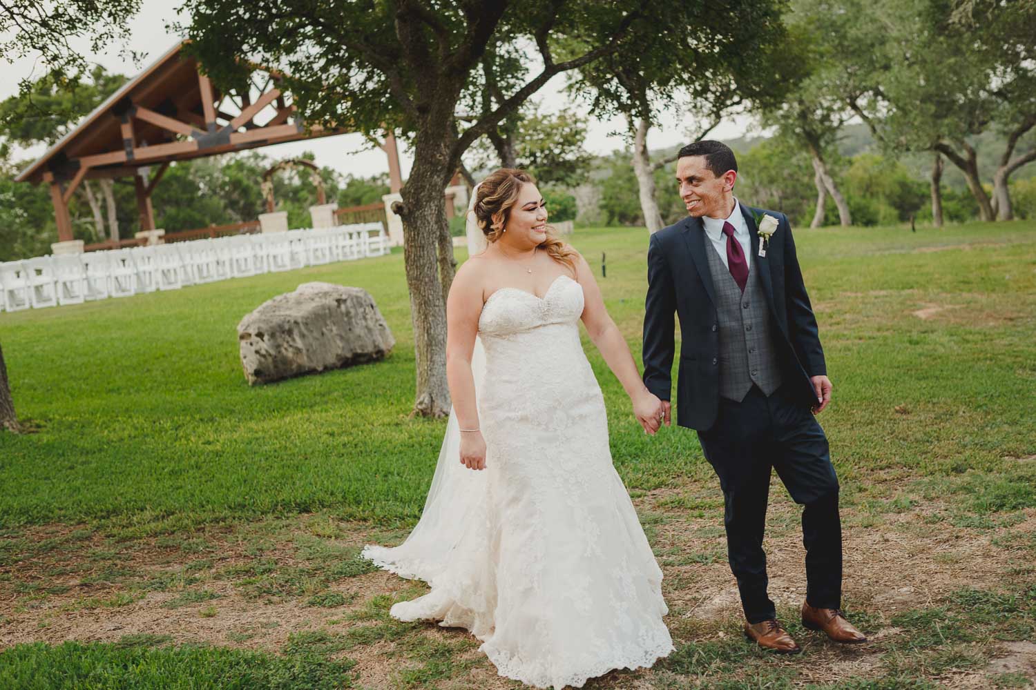 Allison and Eric happily walk for a posed picture at The Springs Event Venue Wedding Photos-Philip Thomas