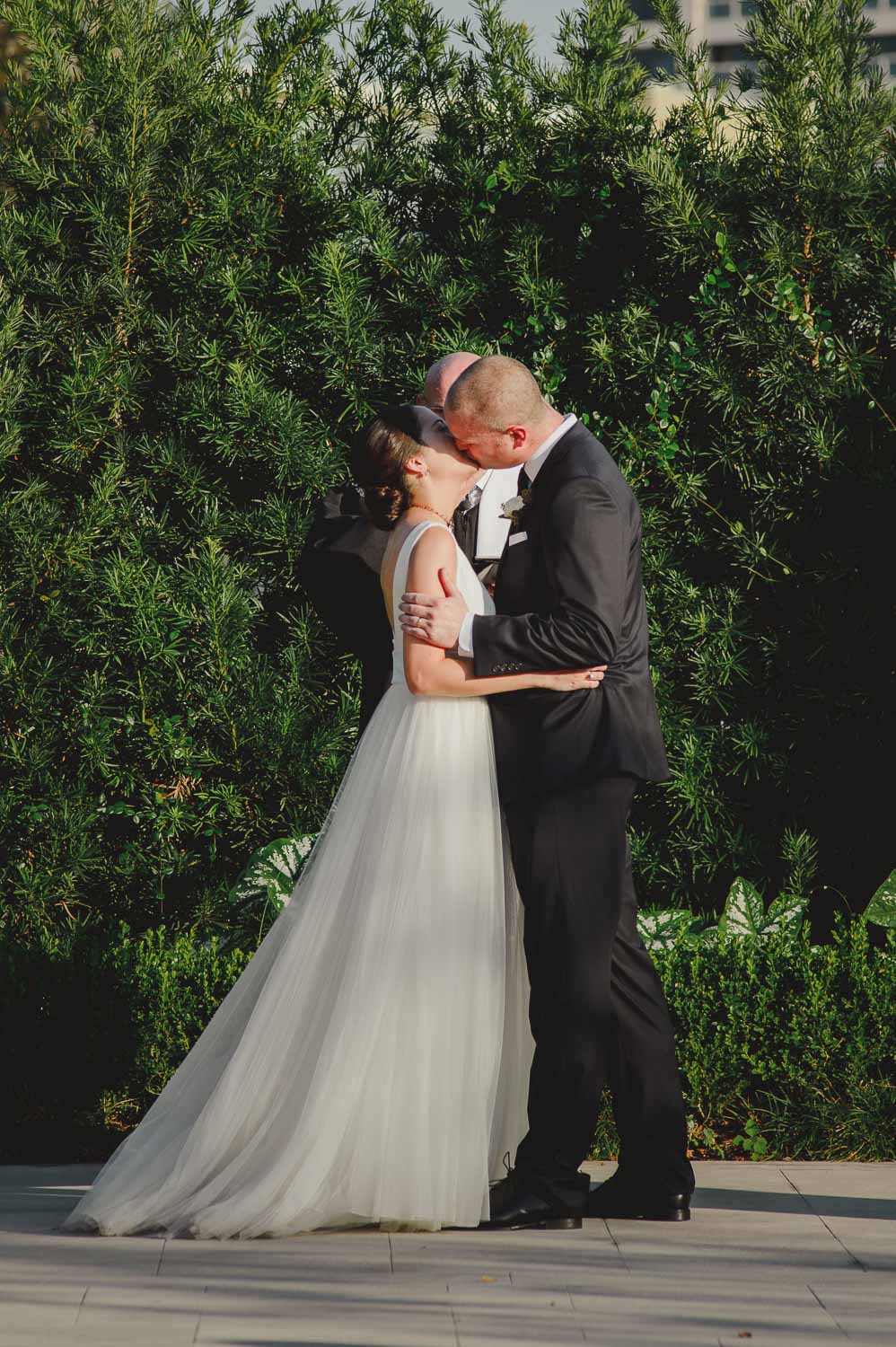 First kiss at end of ceremony during a very hot fall day at Cherie Flores Garden Pavilion Wedding Hermann Park Houston Texas-Philip Thomas