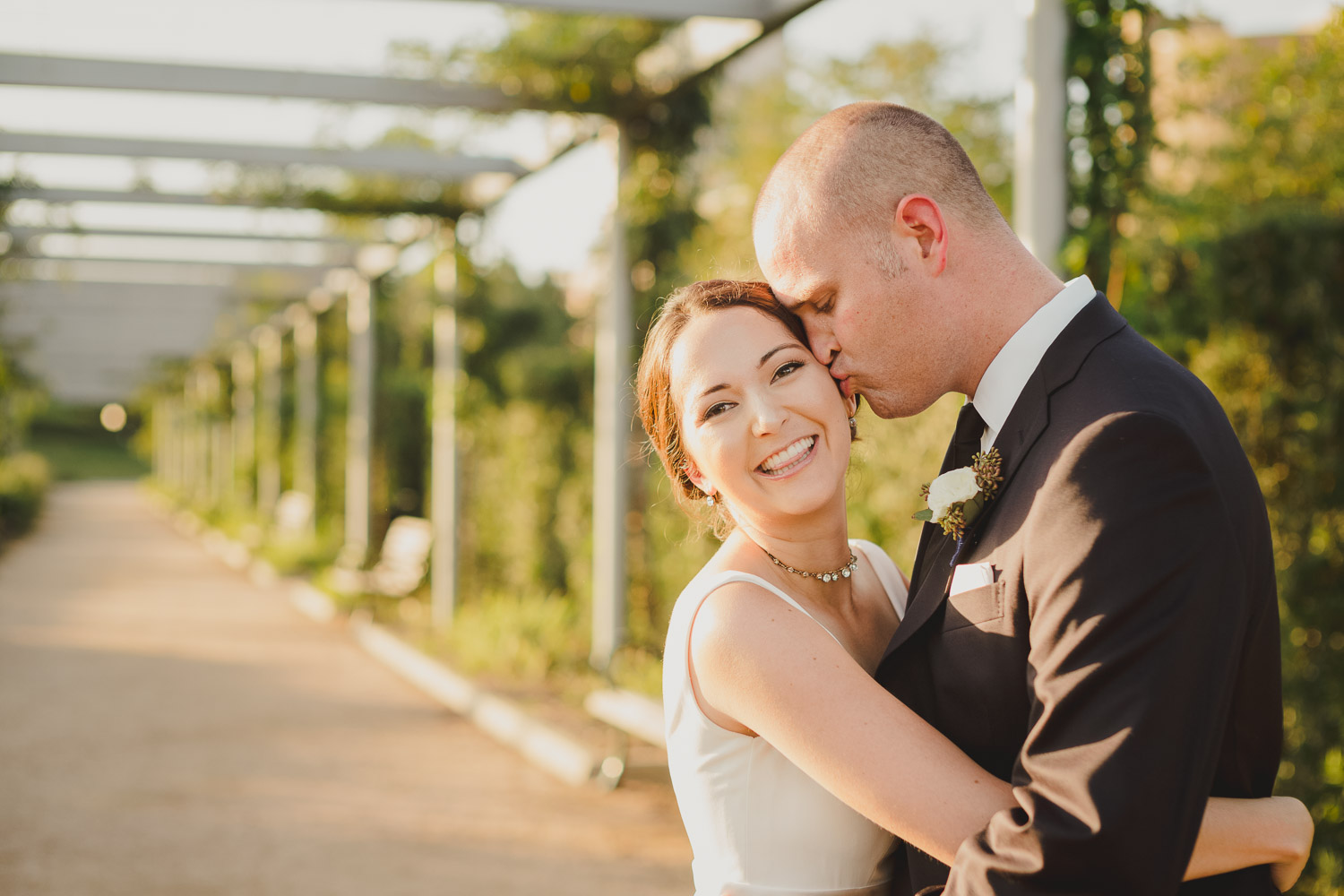 Groom kissed brides side of head beautiful bride at Cherie Flores Garden Pavilion Wedding Hermann Park Houston Texas-Philip Thomas