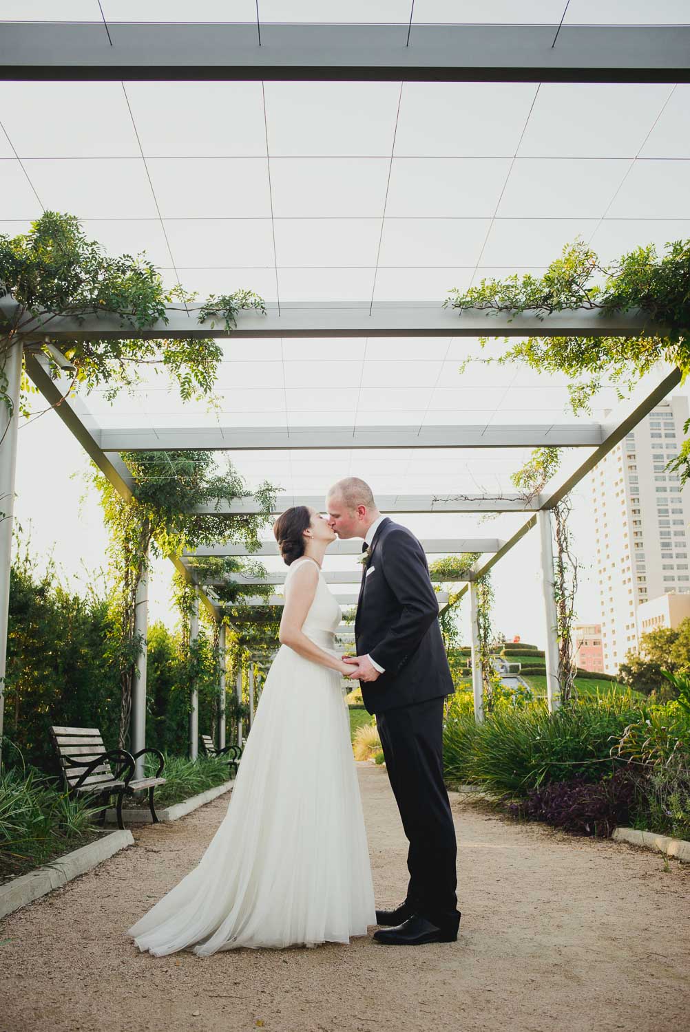 Couple kiss at Cherie Flores Garden Pavilion Wedding Hermann Park Houston Texas-Philip Thomas