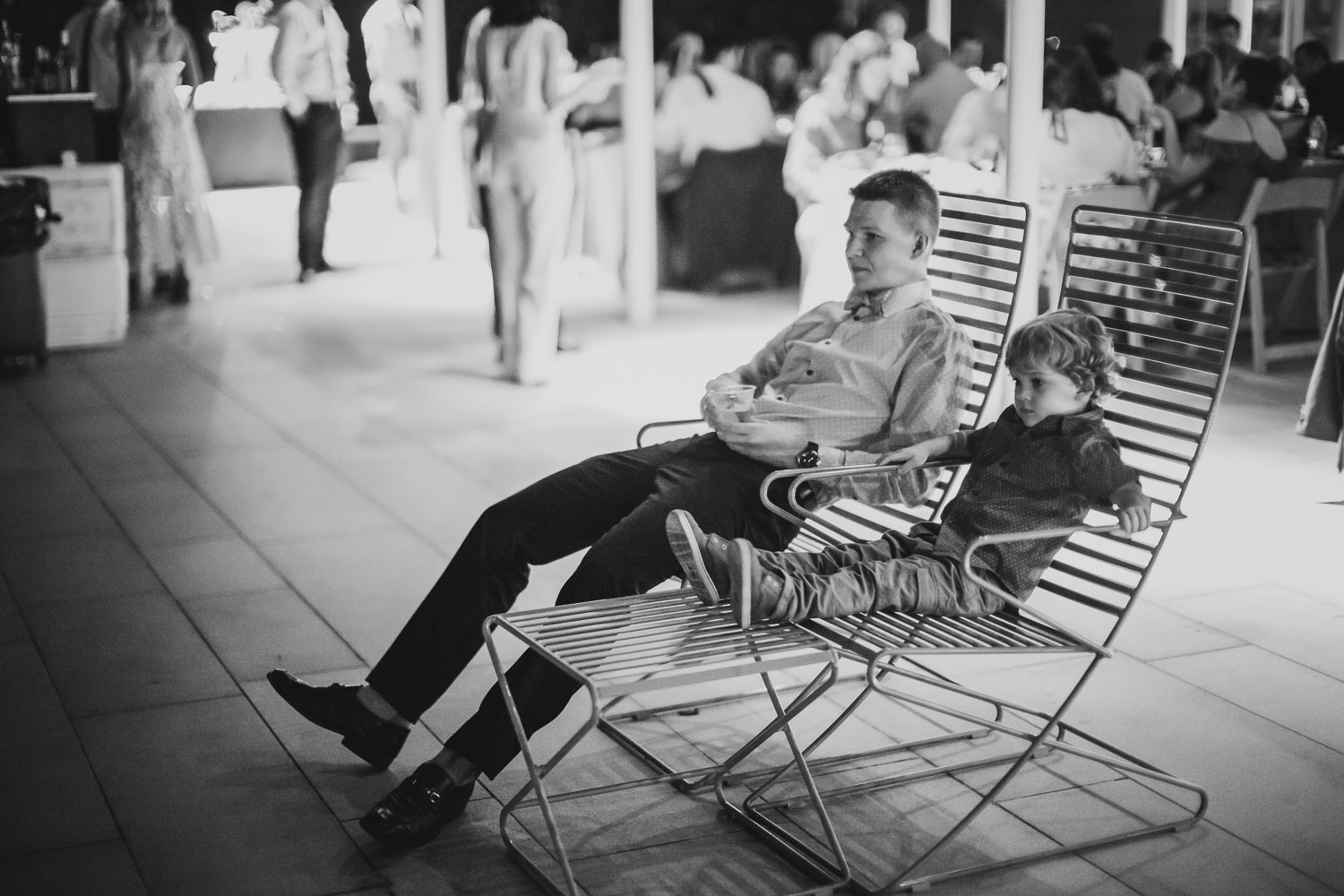 Two younsters sit together on chairs Cherie Flores Garden Pavilion Wedding Hermann Park Houston Texas-Philip Thomas