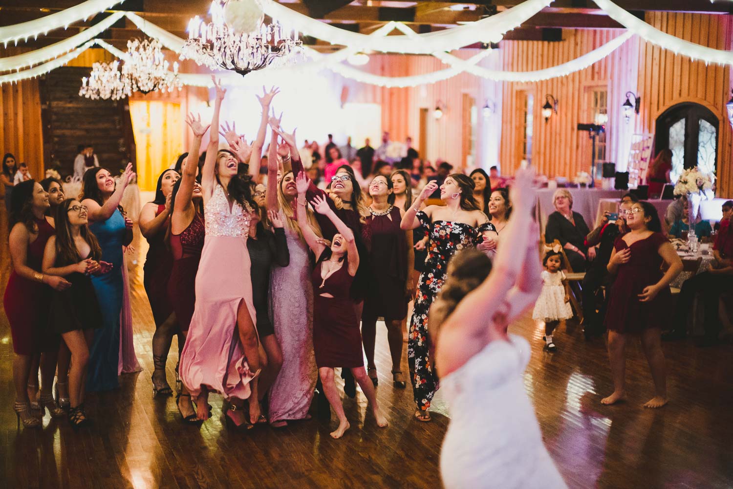 Bride throws her bouquet at -The Springs Event Venue Wedding Photos-Philip Thomas