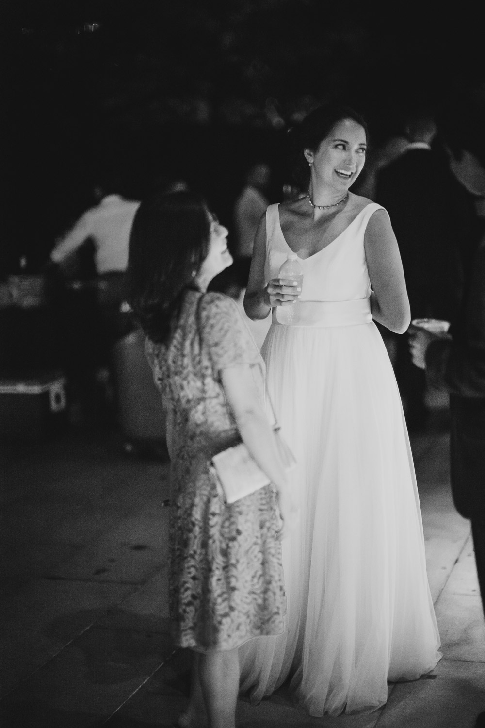 Beautifully lit candid photo of bride during an evening wedding reception Cherie Flores Garden Pavilion Wedding Hermann Park Houston Texas-Philip Thomas