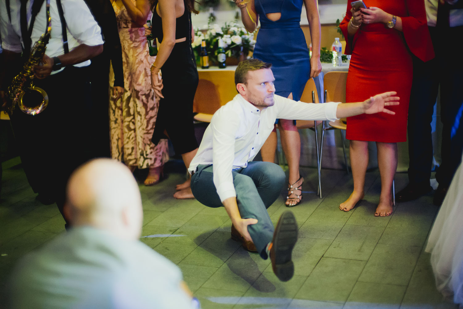 Shenanigans a plenty with a guest hopping low on one leg Cherie Flores Garden Pavilion Wedding Hermann Park Houston Texas-Philip Thomas