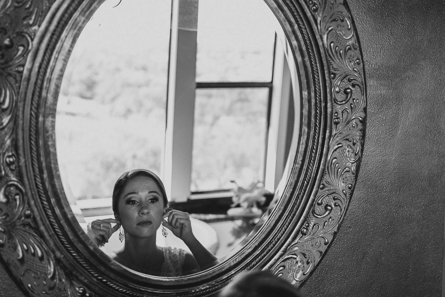 Bride, Katherine checks earrings to wear on her wedding day -Paniolo Ranch Wedding Reception-Philip Thomas