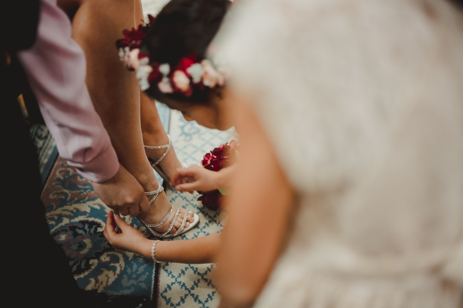 Bride slips into her shoes at Immaculate Conception Chapel at Oblate School of Theology -Philip Thomas