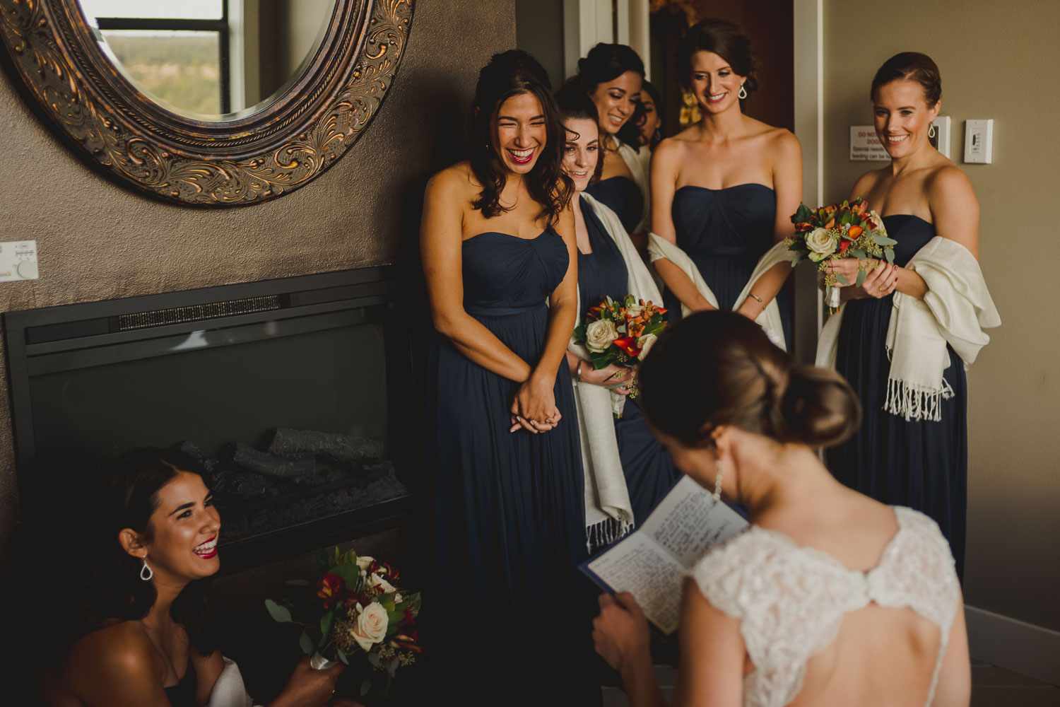 Brides surround the bride and react with happiness as the bride reads a sweet letter from the groom Paniolo Ranch Wedding Reception-Philip Thomas
