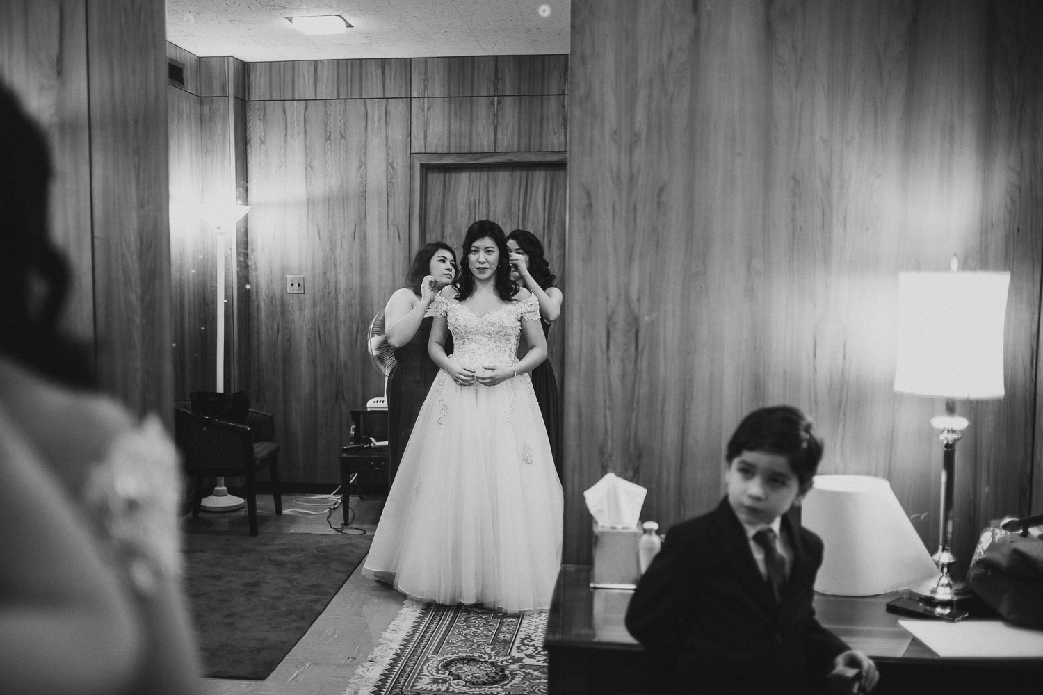 Melody the brides gets dressed at ring bearer follows her closely at Immaculate Conception Chapel at Oblate School of Theology -Philip Thomas