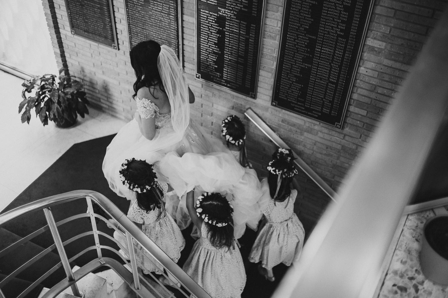 Flower girls help bride up stairwell at Immaculate Conception Chapel at Oblate School of Theology -Philip Thomas