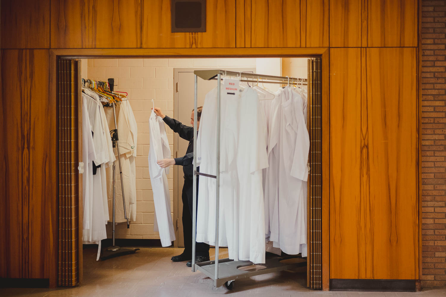 A priest selects the right garment before the wedding ceremony commences at Immaculate Conception Chapel at Oblate School of Theology -Philip Thomas