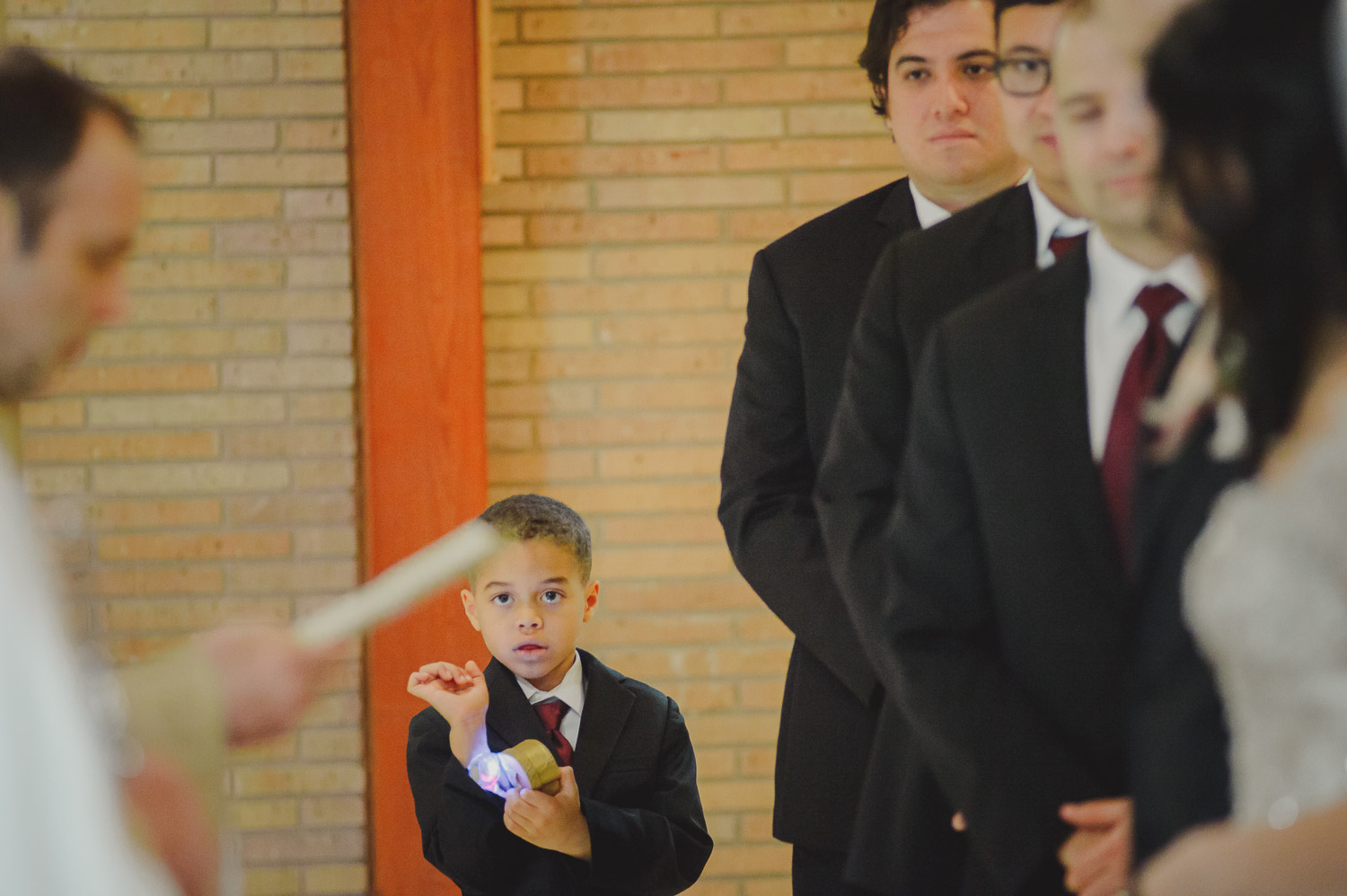 A boy shows of his glowing watch during ceremony at Immaculate Conception Chapel at Oblate School of Theology -Philip Thomas