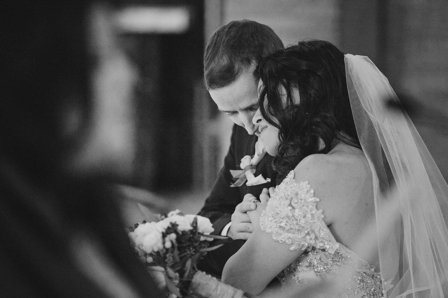 Couple whisper during wedding ceremony at Immaculate Conception Chapel at Oblate School of Theology -Philip Thomas