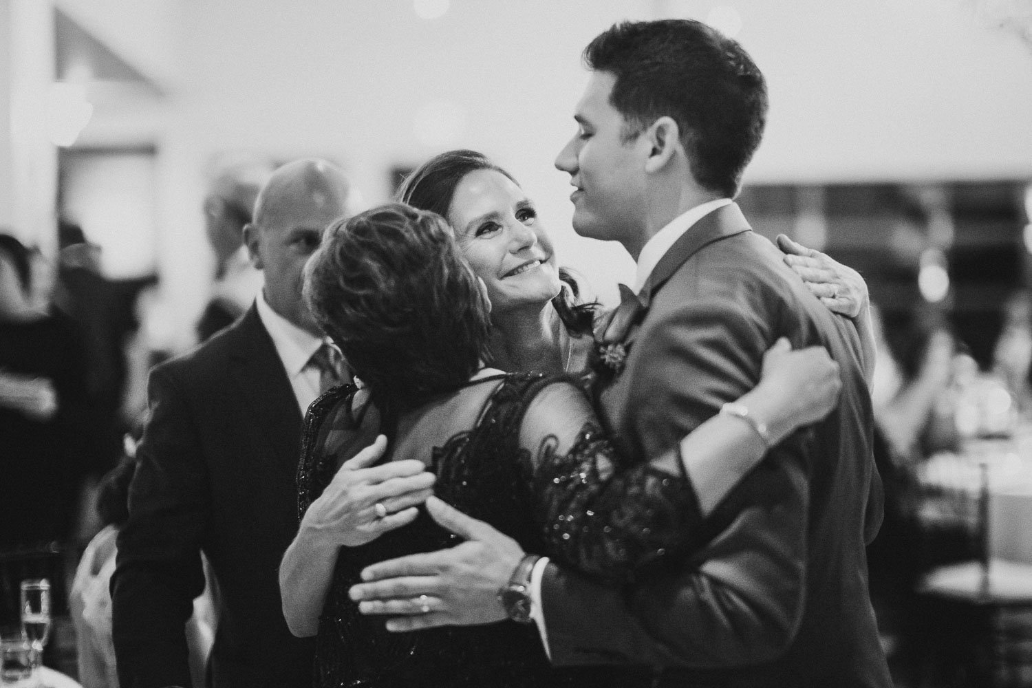Mother of the bride and the groom hug with mother of the bride -Paniolo Ranch Wedding Reception-Philip Thomas