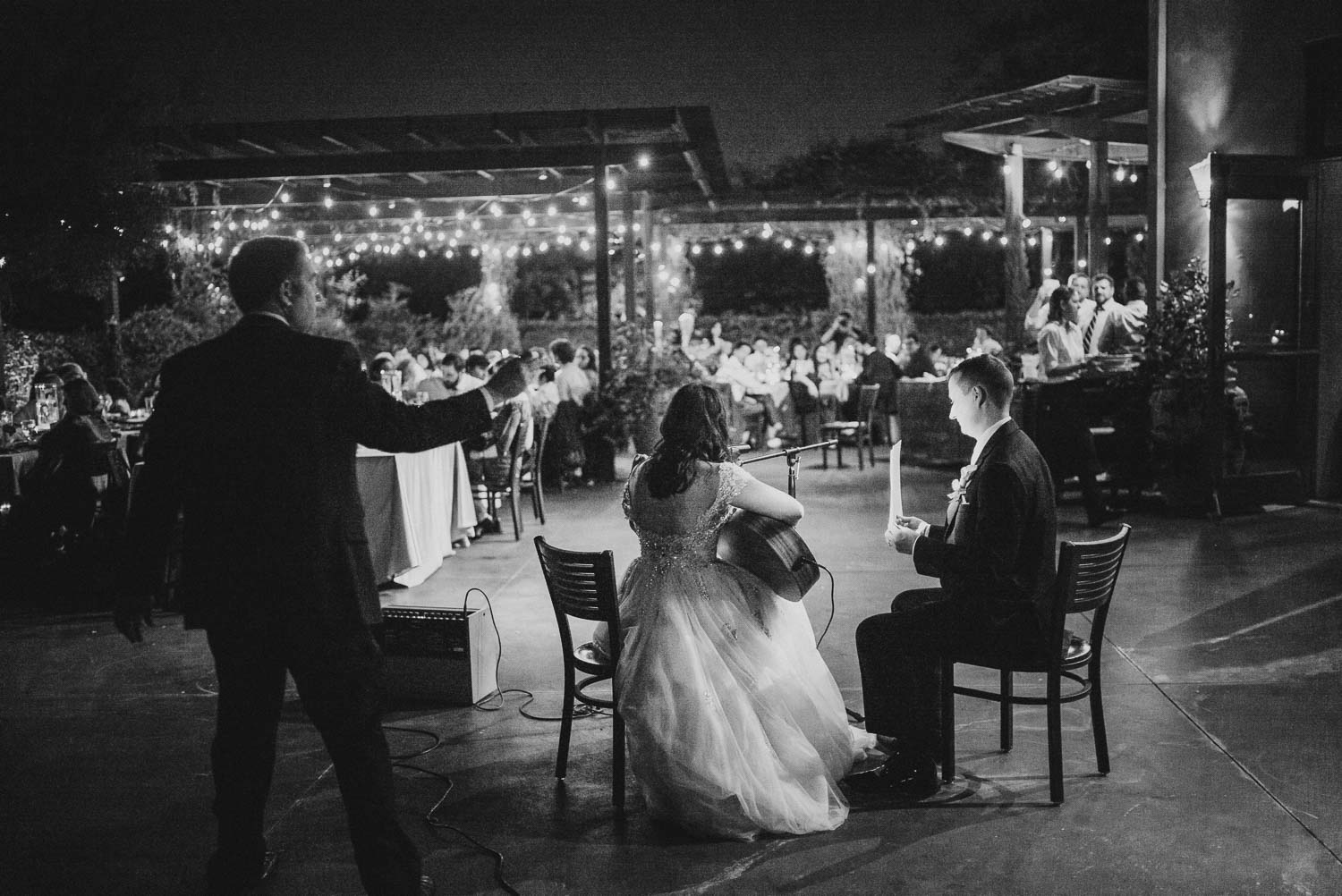 The bride sings a song with guitar to groom at Paesanos 1604 Wedding Reception-Philip Thomas