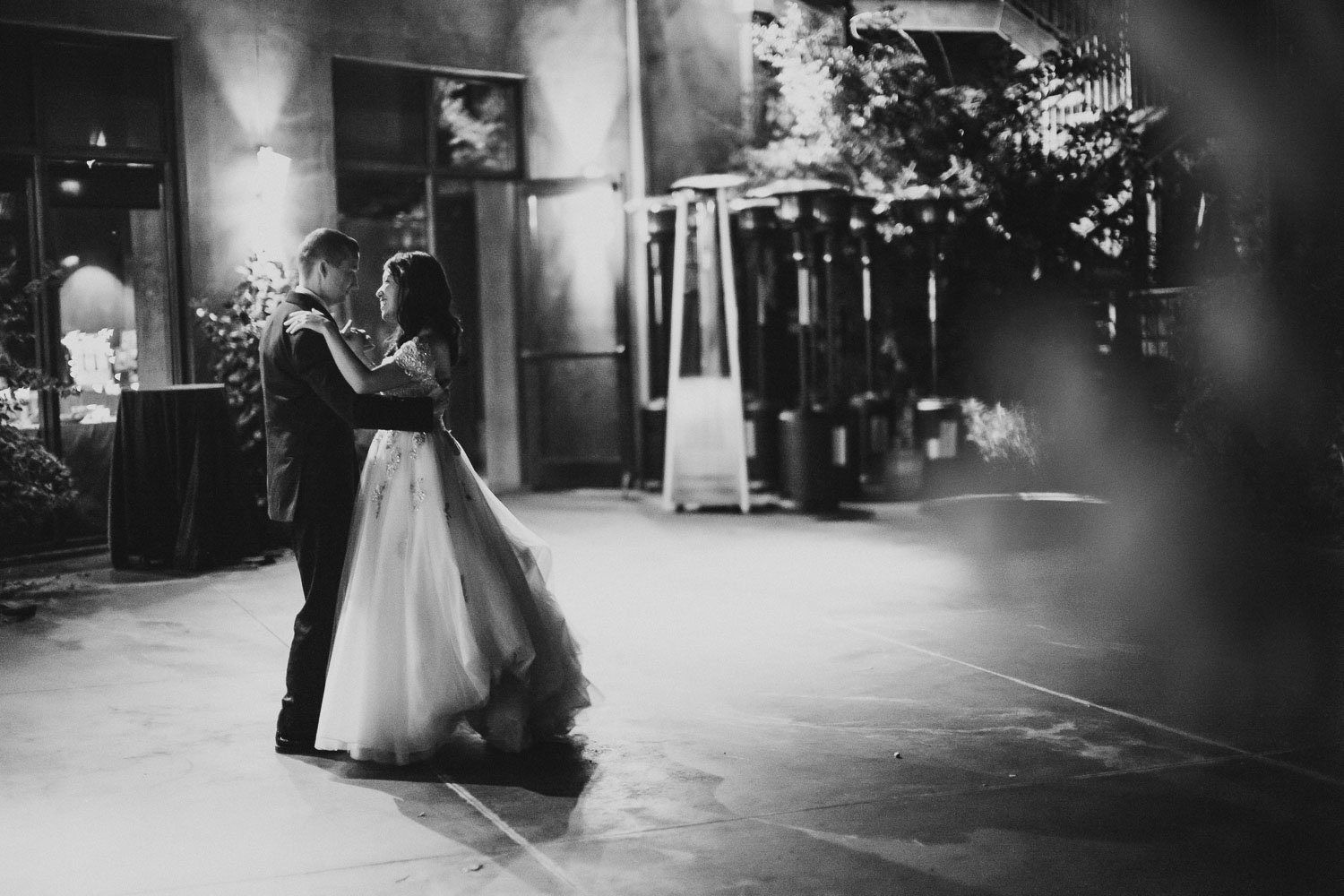 Wide angle black and white shot of couple dancing at Paesanos 1604 Wedding Reception-Philip Thomas