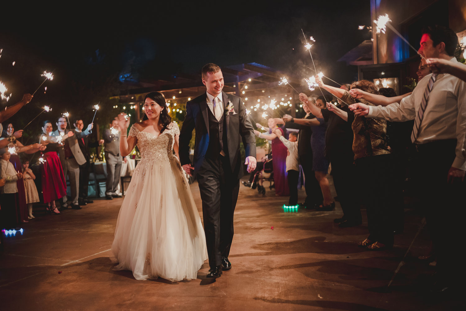 Melody and Alex depart wedding reception with sparklers at Paesanos 1604 Wedding Reception-Philip Thomas