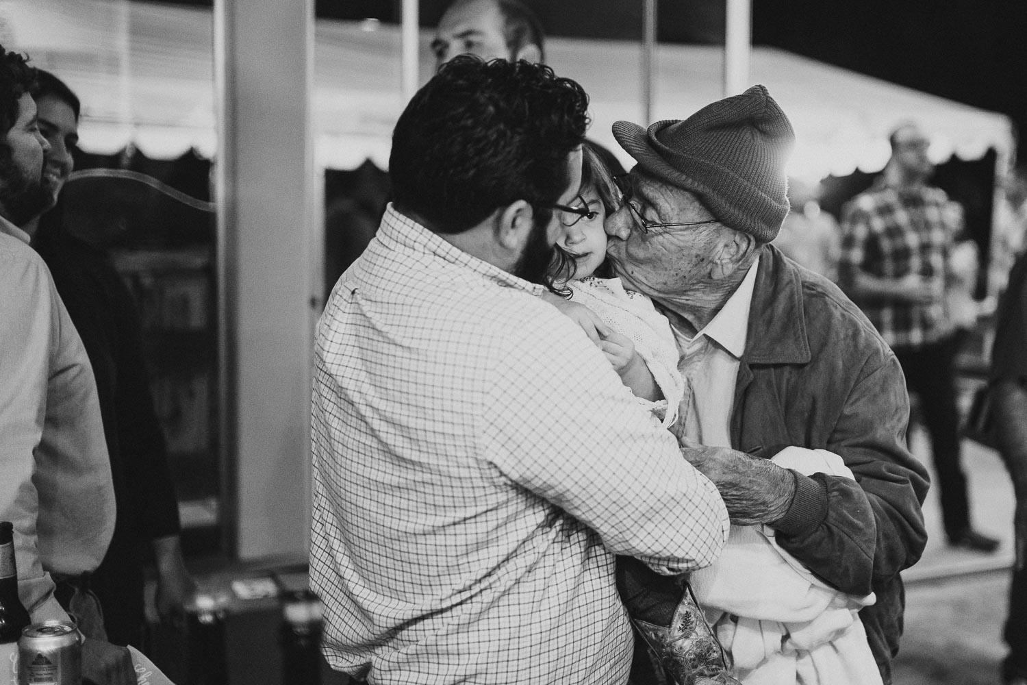 The groom kisses a family member at a rehearsal dinner Liney moon DRIPPING SPRINGS _ BRANDI + AJ-02