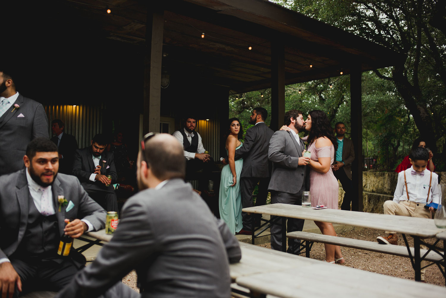 Cocktail party show a guest couple kissing at RUSTIC BARN WEDDING at VISTA WEST RANCH DRIPPING SPRINGS _ BRANDI + AJ-29