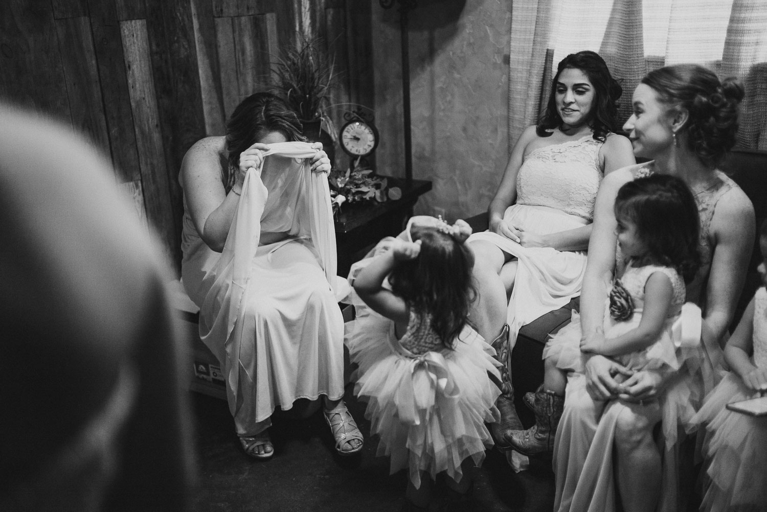 Bridesmaid plays peek-a-boo with flower girl whilst waiting for ceremony to start RUSTIC BARN WEDDING at VISTA WEST RANCH DRIPPING SPRINGS _ BRANDI + AJ-33