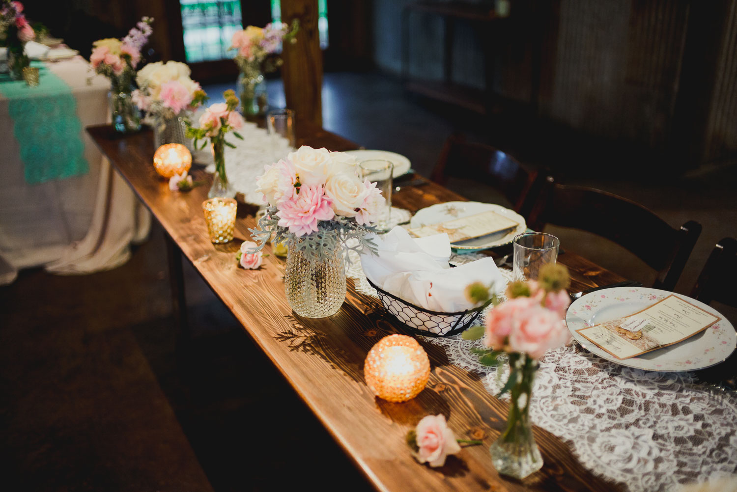 Dinner tables show flowers and beautiful lighting RUSTIC BARN WEDDING at VISTA WEST RANCH DRIPPING SPRINGS _ BRANDI + AJ-46