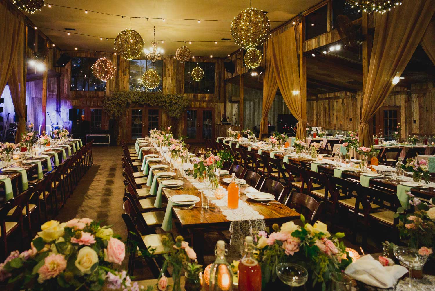 Wide shot of dinner tables RUSTIC BARN WEDDING at VISTA WEST RANCH DRIPPING SPRINGS _ BRANDI + AJ-54