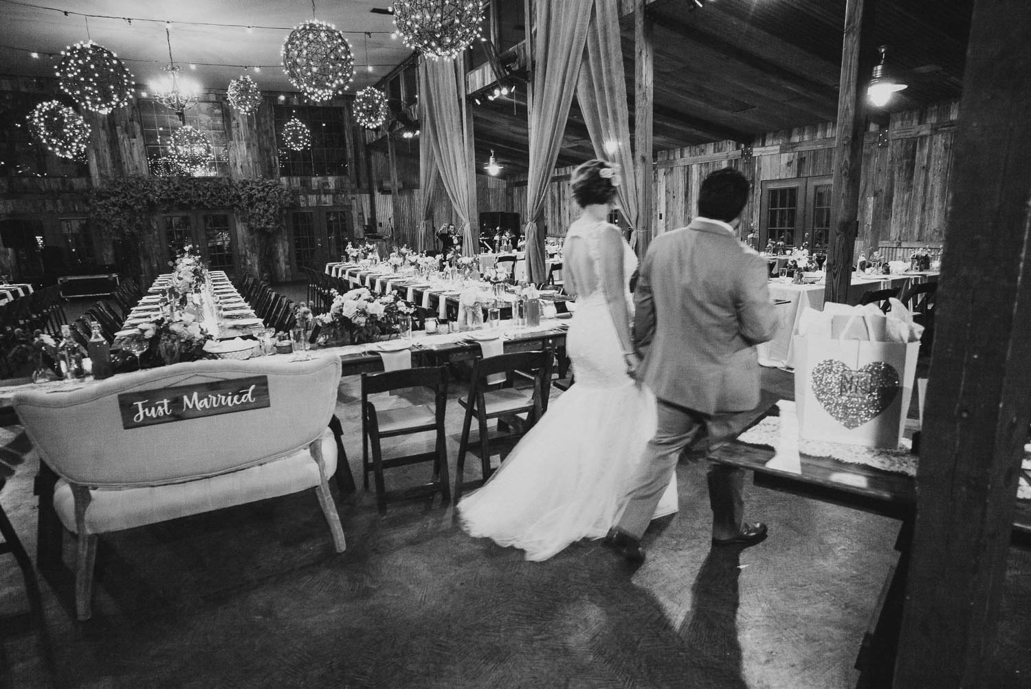 Couple enter the wedding reception for the first time RUSTIC BARN WEDDING at VISTA WEST RANCH DRIPPING SPRINGS _ BRANDI + AJ-55