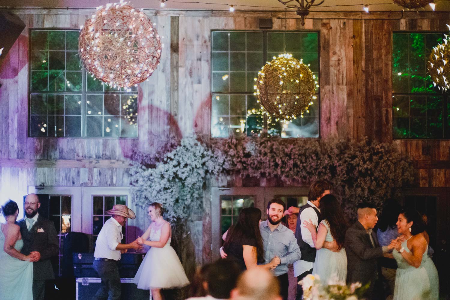 Wide shot shows bridal party and guests dancing RUSTIC BARN WEDDING at VISTA WEST RANCH DRIPPING SPRINGS _ BRANDI + AJ-75