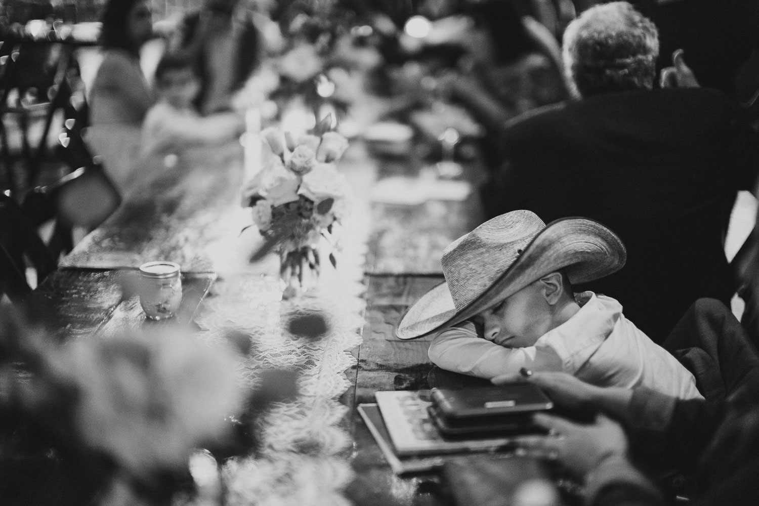 A little boy falls asleep at a wedding reception RUSTIC BARN WEDDING at VISTA WEST RANCH DRIPPING SPRINGS _ BRANDI + AJ-80