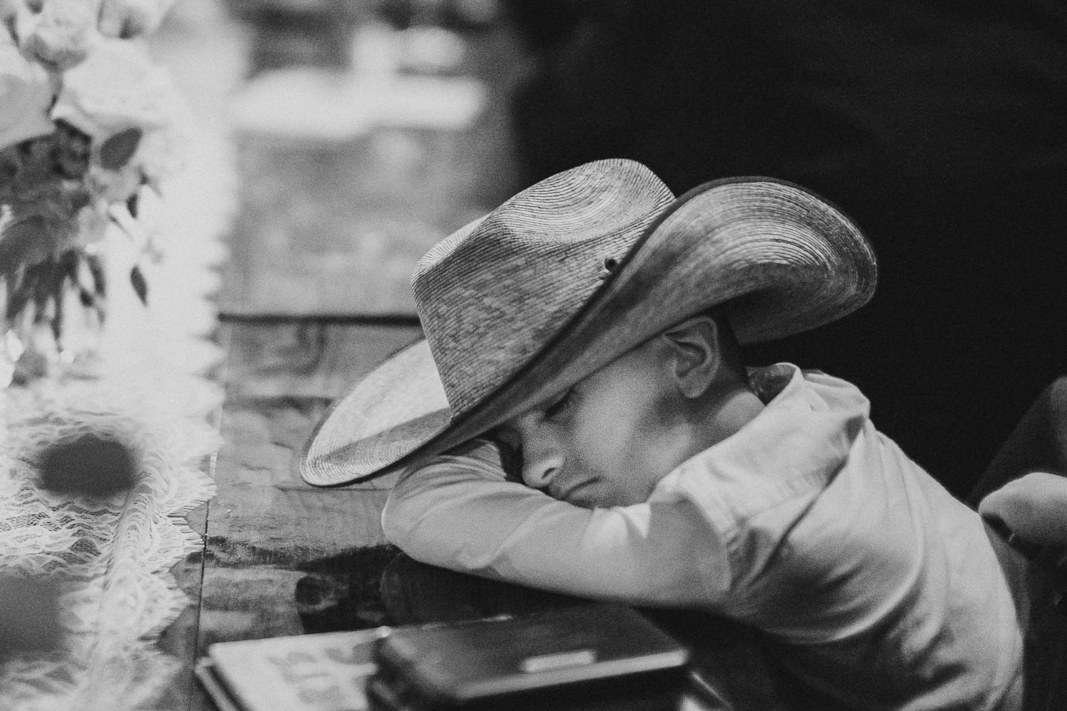 A little boy falls asleep at a wedding reception RUSTIC BARN WEDDING at VISTA WEST RANCH DRIPPING SPRINGS _ BRANDI + AJ-80