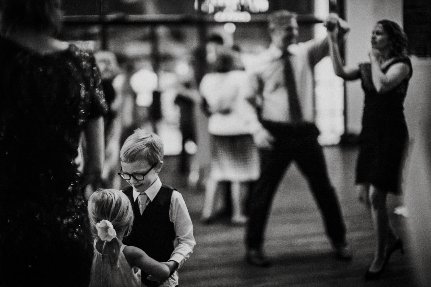 Wedding photographer Philip Thomas captures child pulling another childs foot as couple dance and twirl at a wedding reception Hayes Hollow at HIdden Falls 2222 Bridal Veil Spring Branch-Wedding photographer-Philip Thomas-043