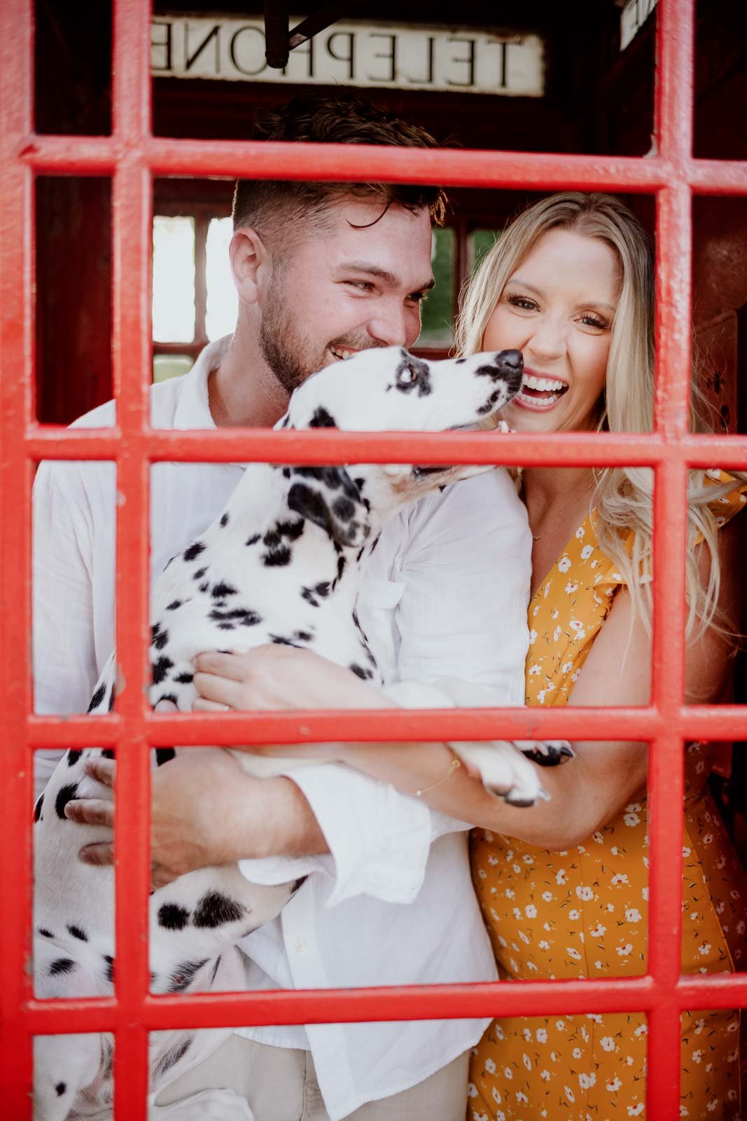 Couples engagement photo in a British telephone box at the Black Labrador Houston