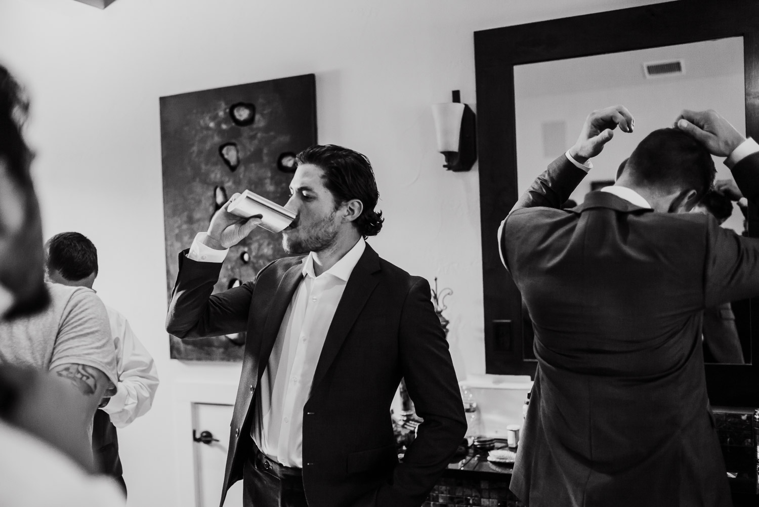 A groom at Hidden falls Bridal Veil swallows some liquid courage.